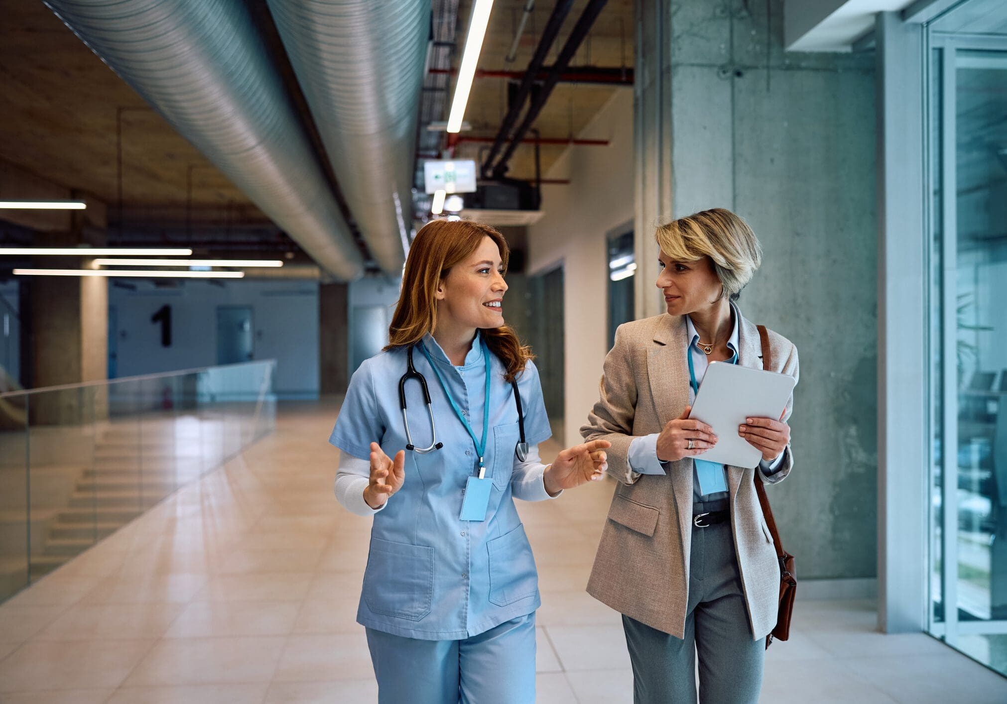 Two colleagues in hospital corridor